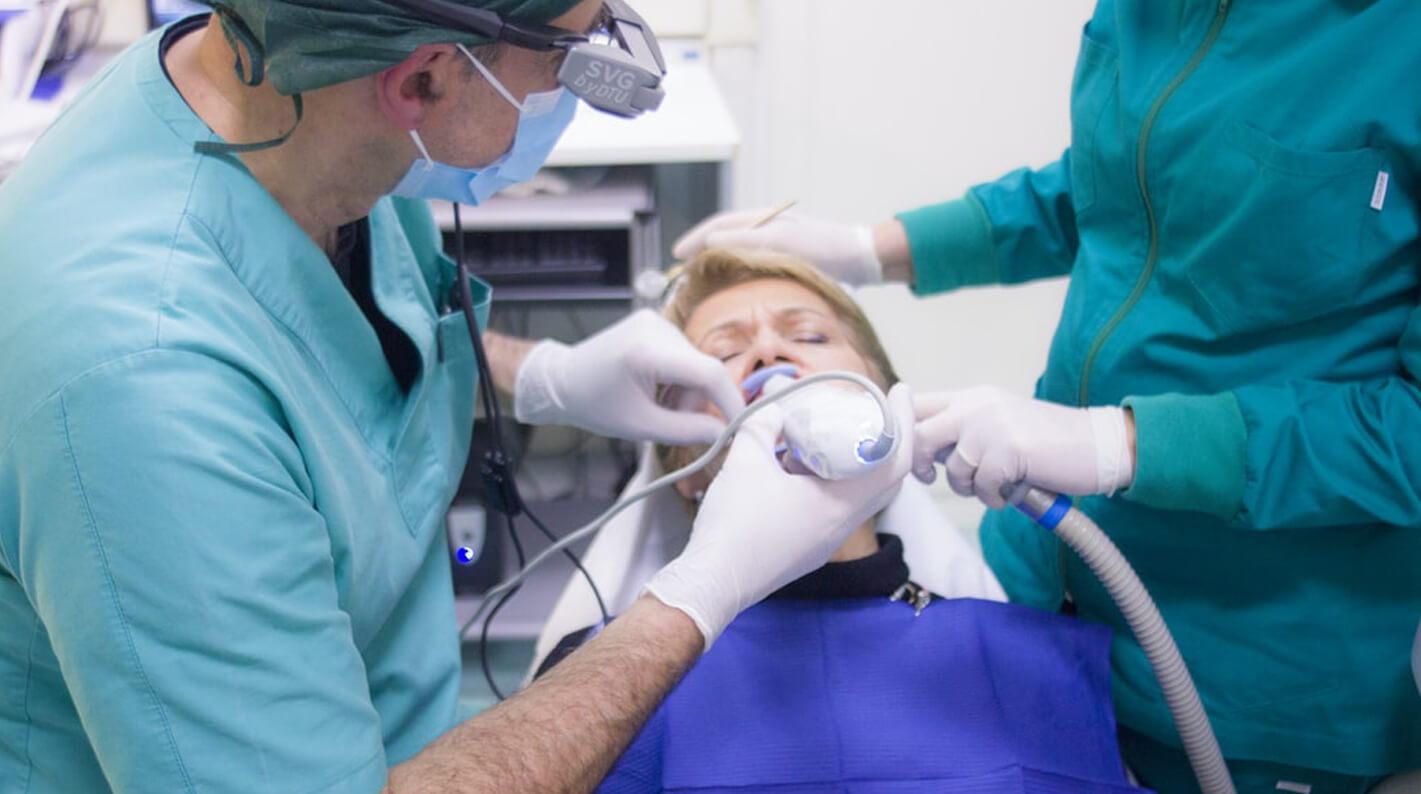 dentist with gloves attending to patient